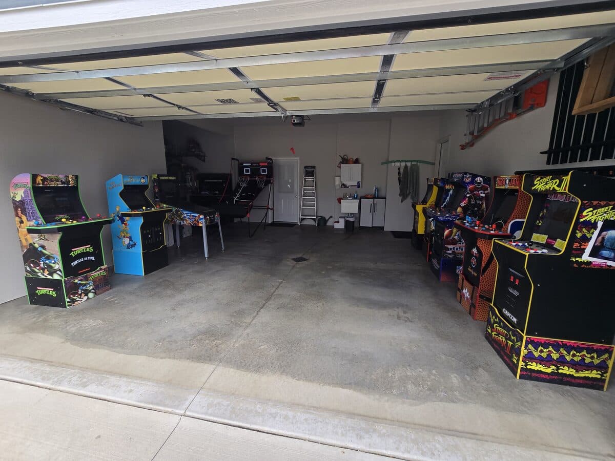 Classic arcade cabinets, including Turtles in Time and Street Fighter II, set up in a garage for a birthday party in Fort Wayne
